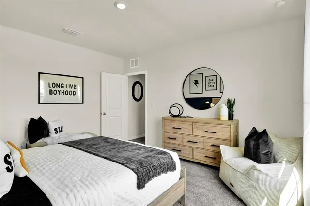 a bedroom with a bed and a dresser