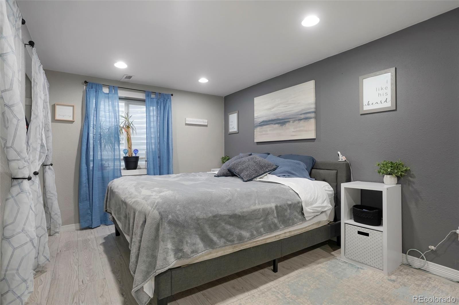 9201 West 104th Place Westminster, CO 80021 - Photo 11 of 29 a spacious bedroom with a bed and a potted plant