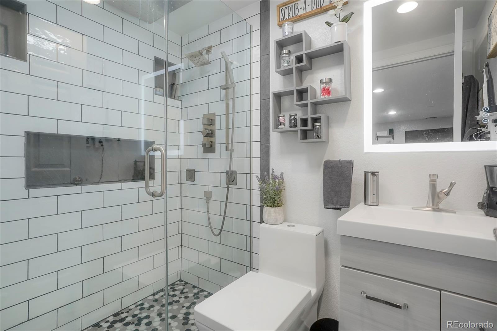 9201 West 104th Place Westminster, CO 80021 - Photo 13 of 29 a bathroom with a sink toilet and shower