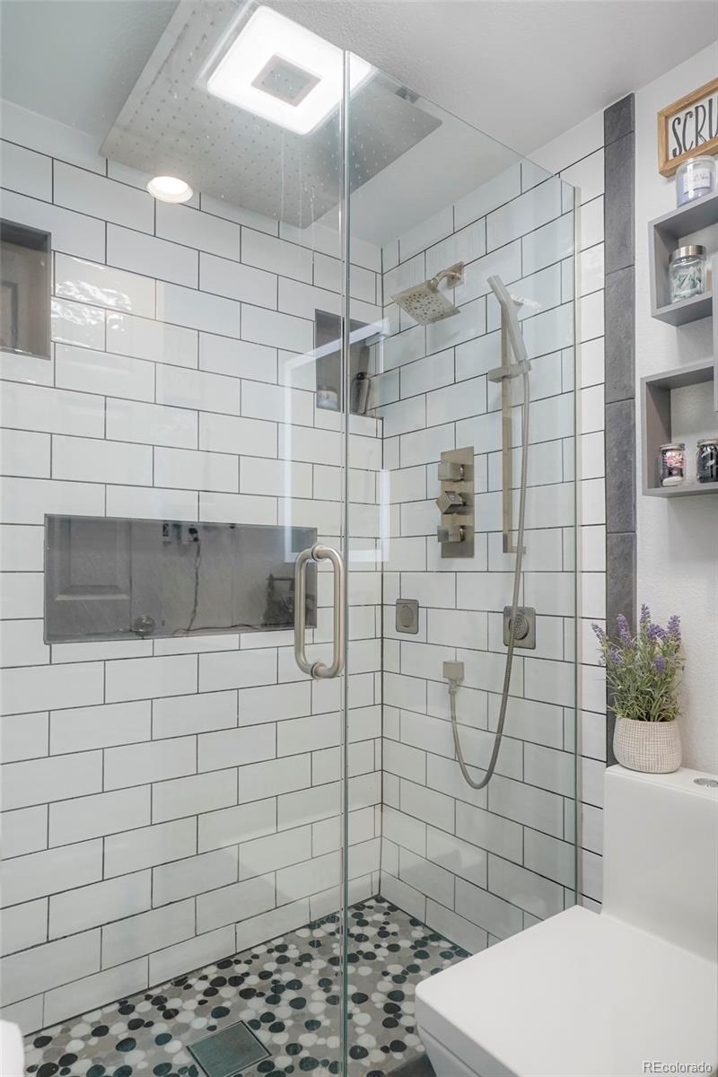 9201 West 104th Place Westminster, CO 80021 - Photo 14 of 29 a bathroom with a toilet and a shower