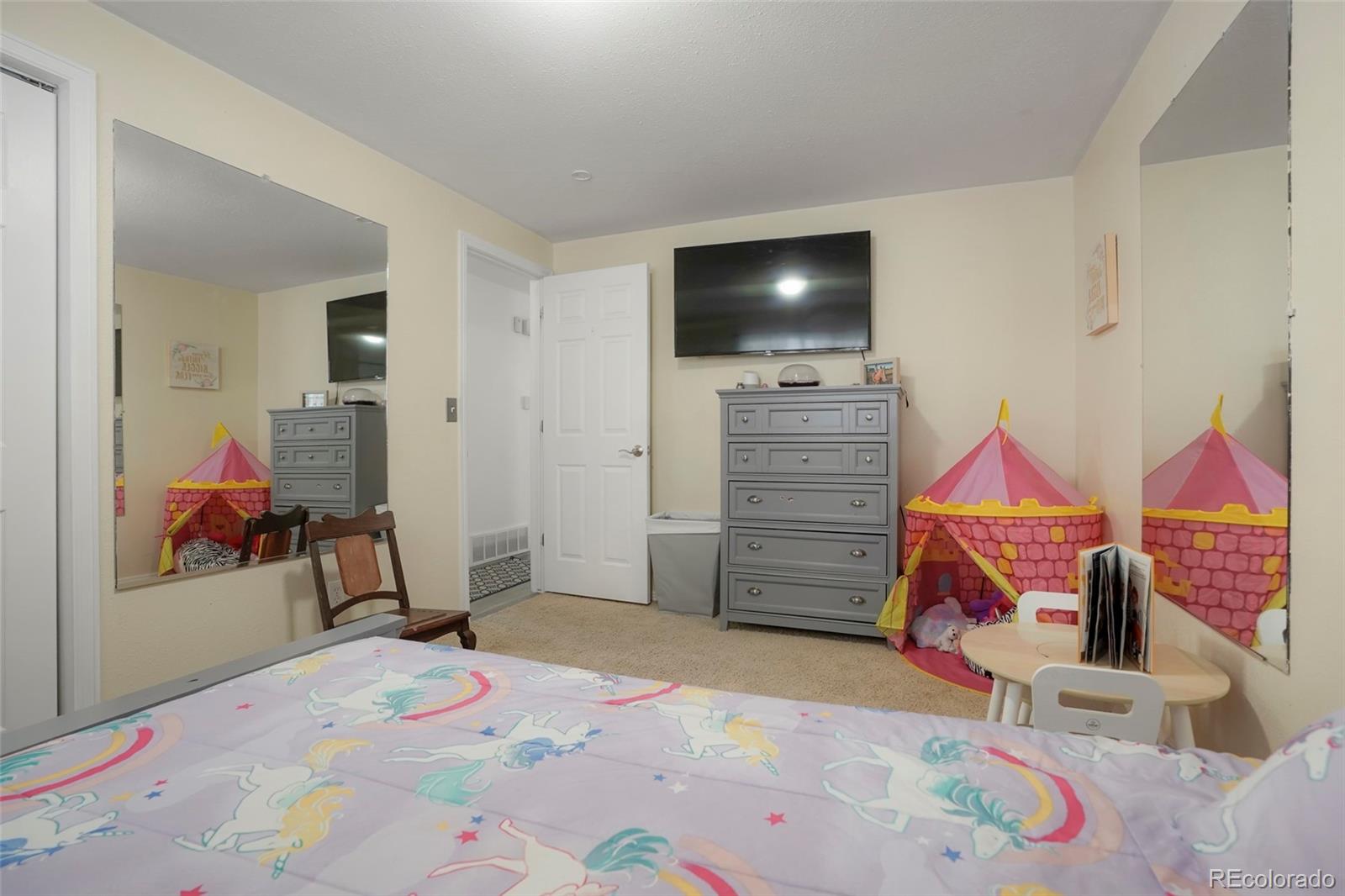 9201 West 104th Place Westminster, CO 80021 - Photo 18 of 29 a bedroom with a bed and a dresser