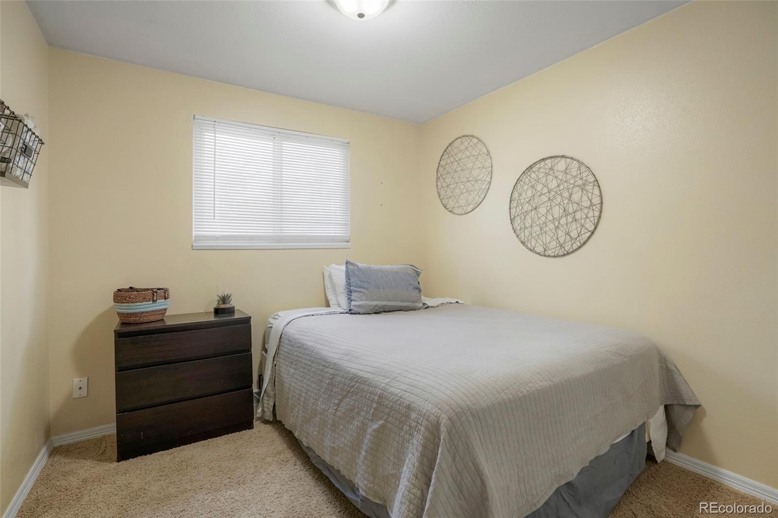 9201 West 104th Place Westminster, CO 80021 - Photo 19 of 29 a bedroom with a bed and a closet