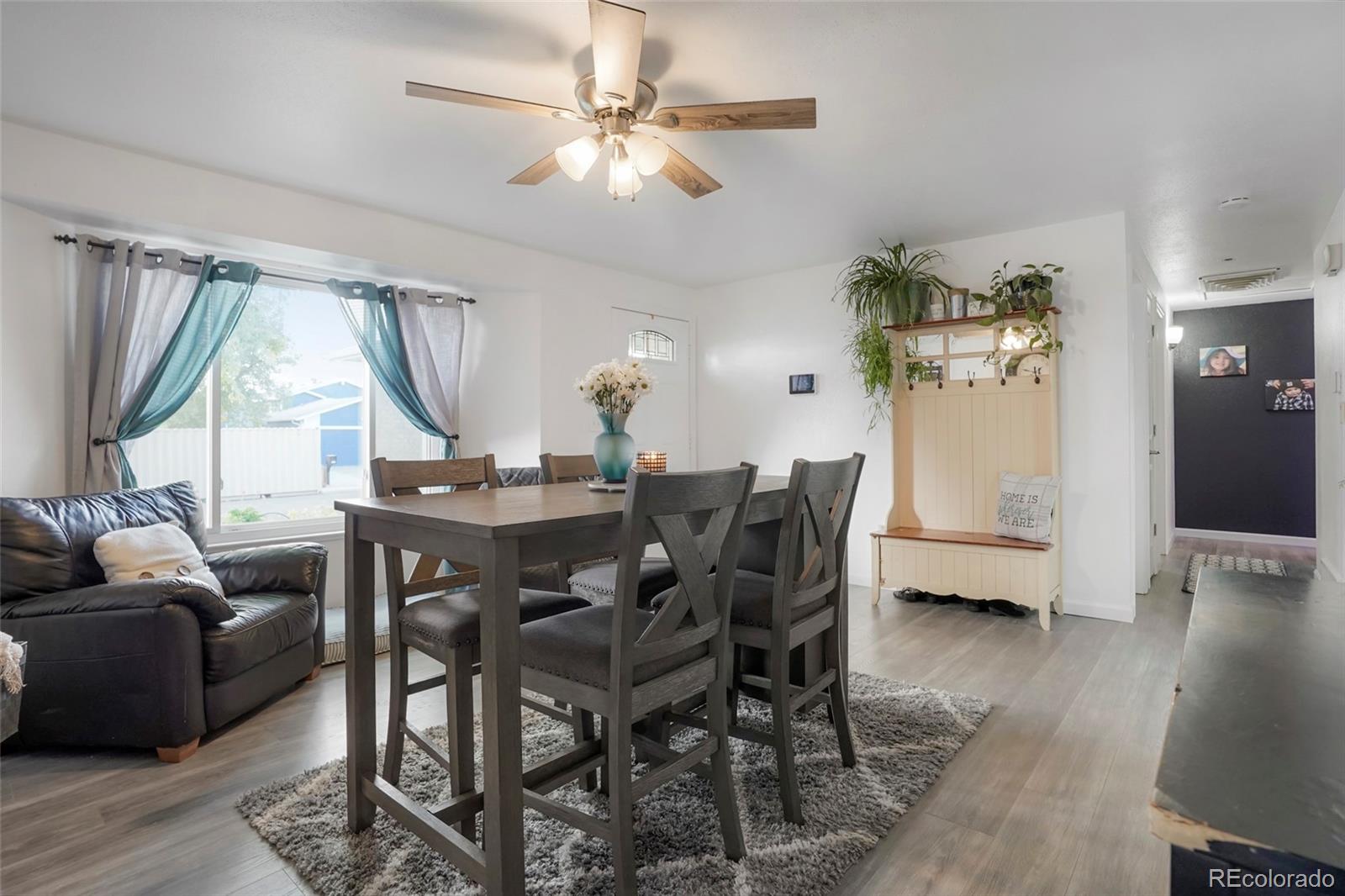 9201 West 104th Place Westminster, CO 80021 - Photo 4 of 29 a view of a dining room with furniture window and wooden floor