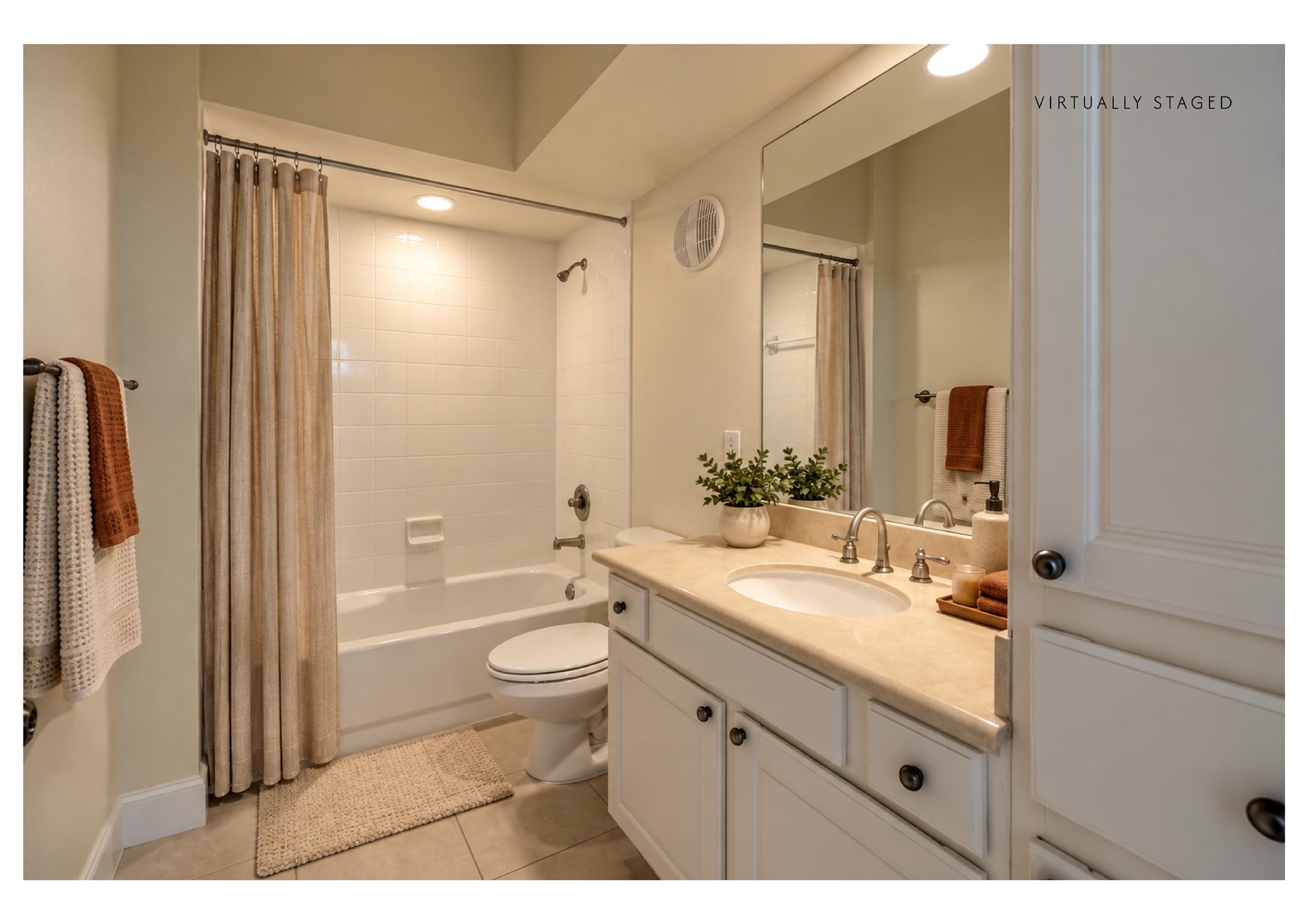 7701 Rialto Boulevard, Unit 1326 Austin, TX 78735 - Photo 19 of 20 The staged version shows how it could look: smooth tile surrounds the bathtub and shower in this bright, clean bathroom design.