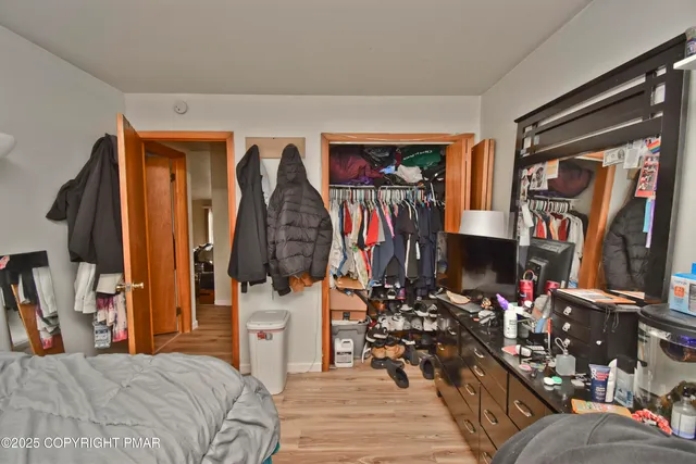 a bedroom with a bed and a mirror