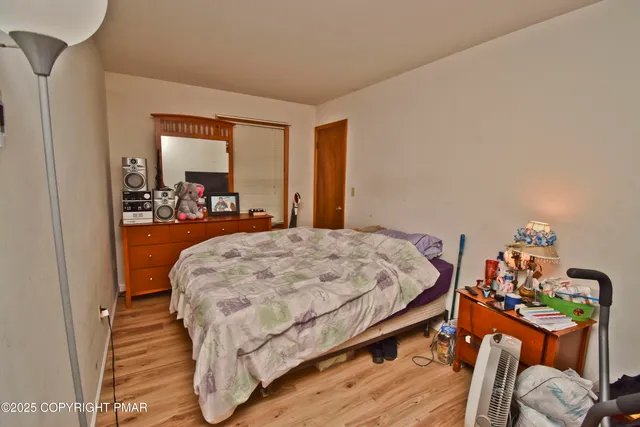 a bed sitting in a bedroom next to a window