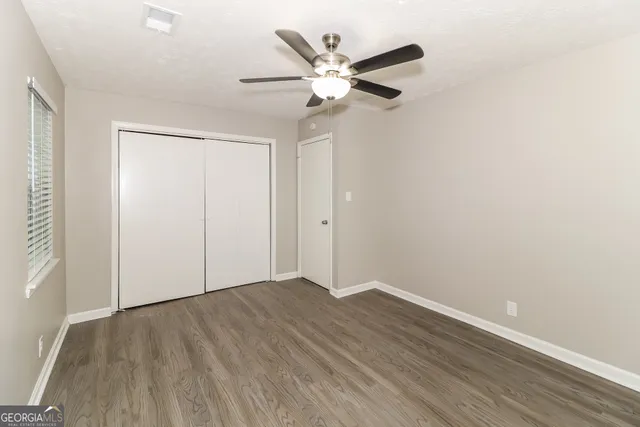 a view of an empty room with wooden floor