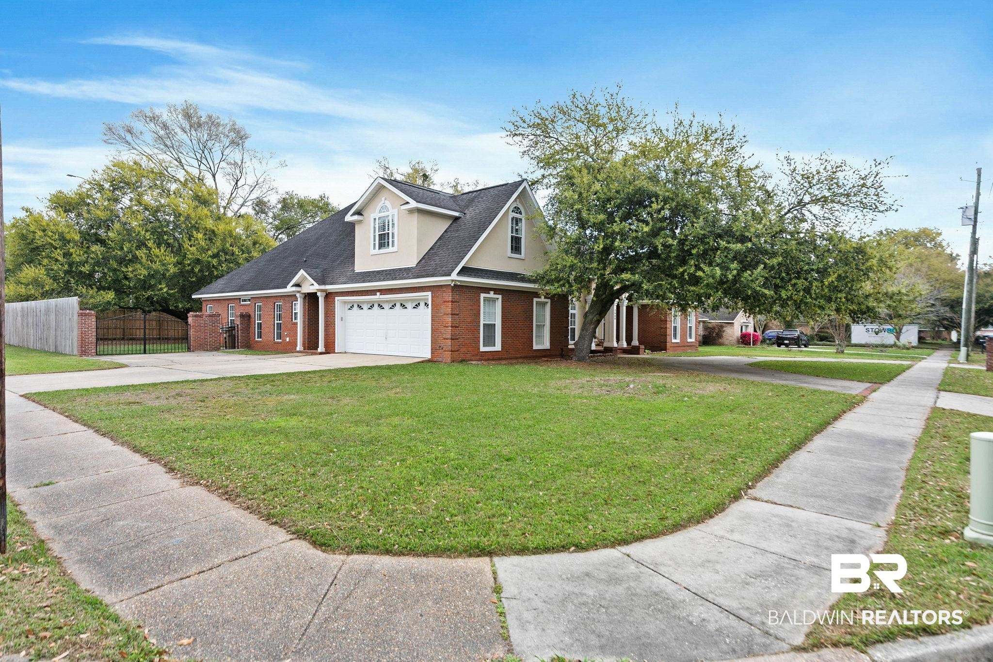 3668 Claridge Road North Mobile, AL 36608 - Photo 16 of 100 View of front facade featuring driveway, brick siding, and a gate