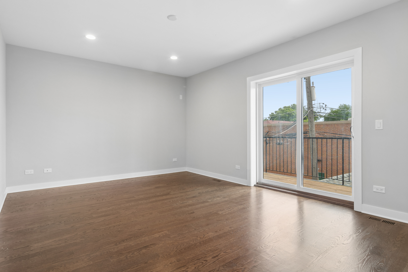 4845 North Keystone Avenue, Unit 2N Chicago, IL 60630 - Photo 10 of 21 an empty room with wooden floor and windows