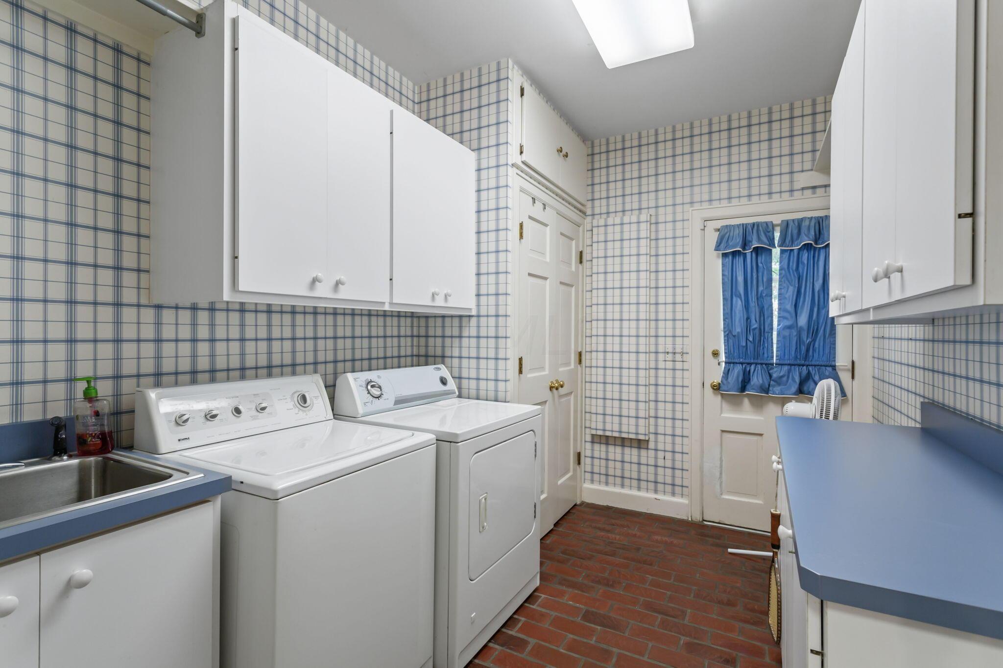 2111 Cheltenham Road Columbus, OH 43220 - Photo 25 of 64 Laundry room has a washer and dryer which can convey with the property, nice storage and a utility sink along with laundry chute.
