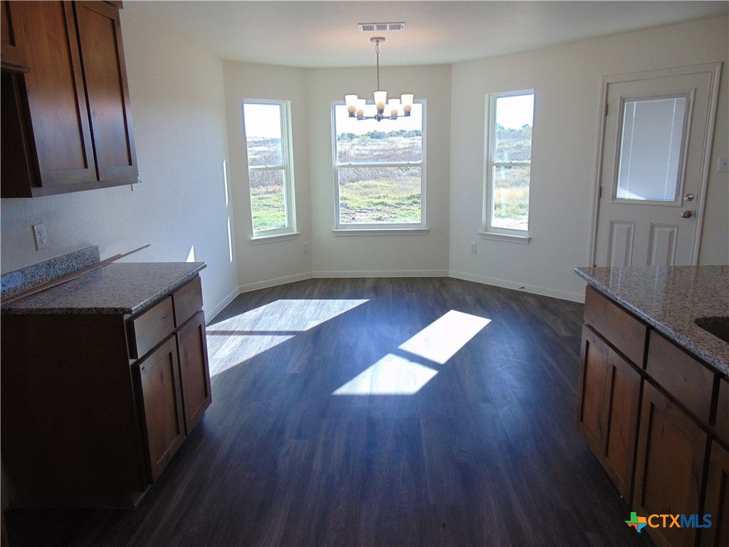 3202 Salt Fork Drive Killeen, TX 76549 - Photo 8 of 25 a hallway with wooden floors and chandelier