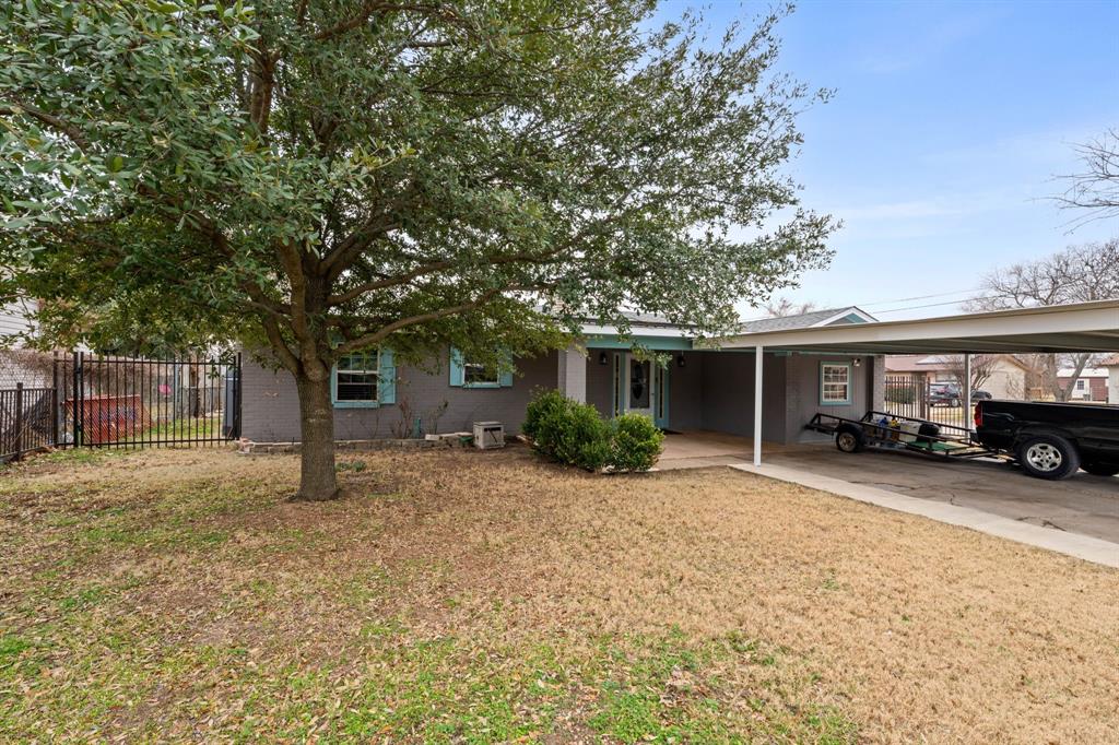 a view of a house with a tree in front of it