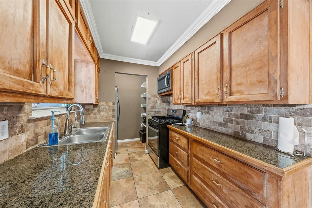 1530 Carson Drive Mesquite, TX 75149 - Photo 13 of 21 a kitchen with stainless steel appliances granite countertop a sink a stove and cabinets