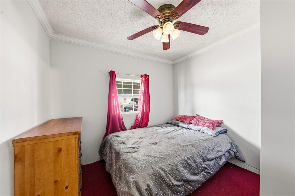 1530 Carson Drive Mesquite, TX 75149 - Photo 17 of 21 a bedroom with a bed and a chandelier