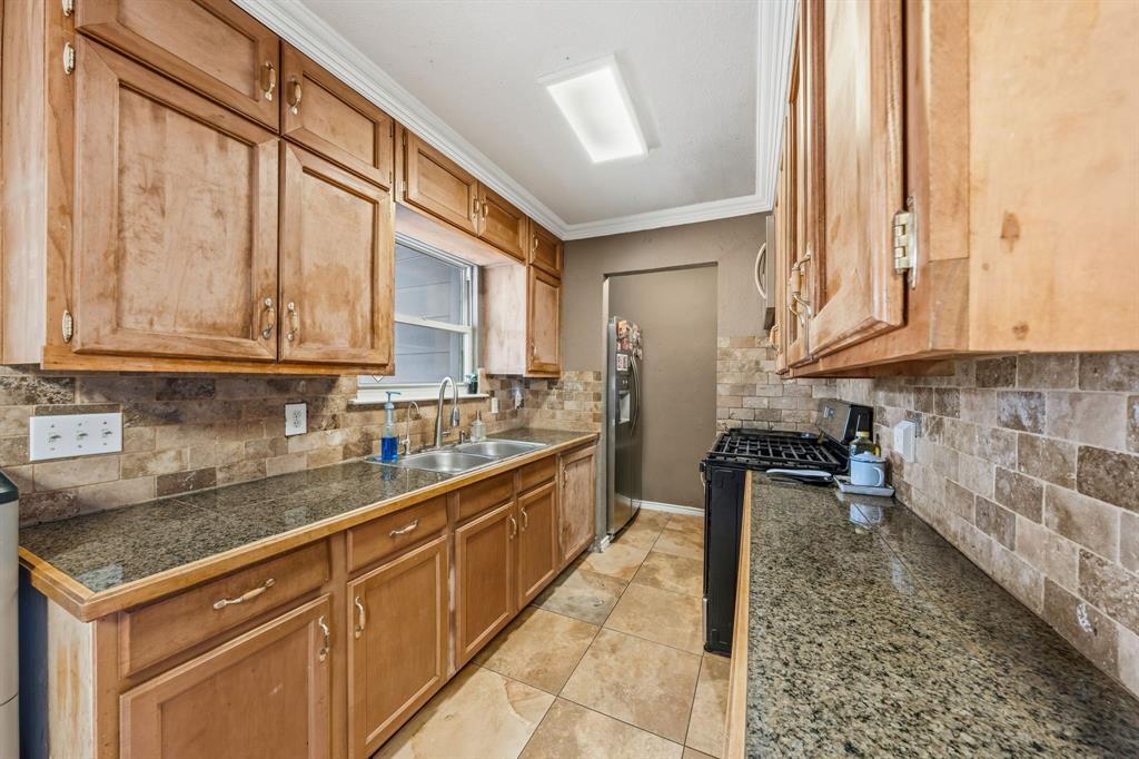 1530 Carson Drive Mesquite, TX 75149 - Photo 10 of 21 a kitchen with stainless steel appliances granite countertop a stove a sink and a microwave