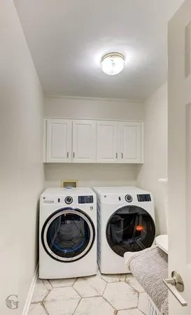 a utility room with a sink a washer and dryer