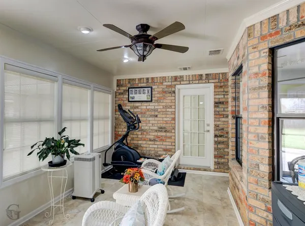 a view of a livingroom with furniture and a ceiling fan