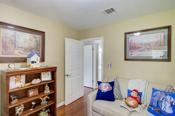 a living room with furniture and a book shelf