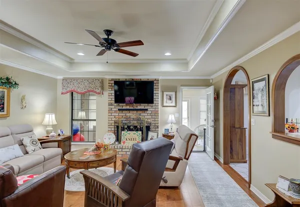 a living room with furniture a fireplace and a flat screen tv