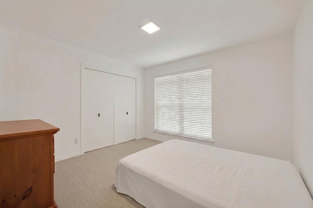 1415 South Joe Wilson Road Cedar Hill, TX 75104 - Photo 14 of 17 a bedroom with a bed and a window