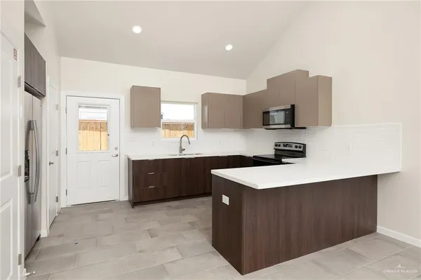 a kitchen with a sink a stove and cabinets