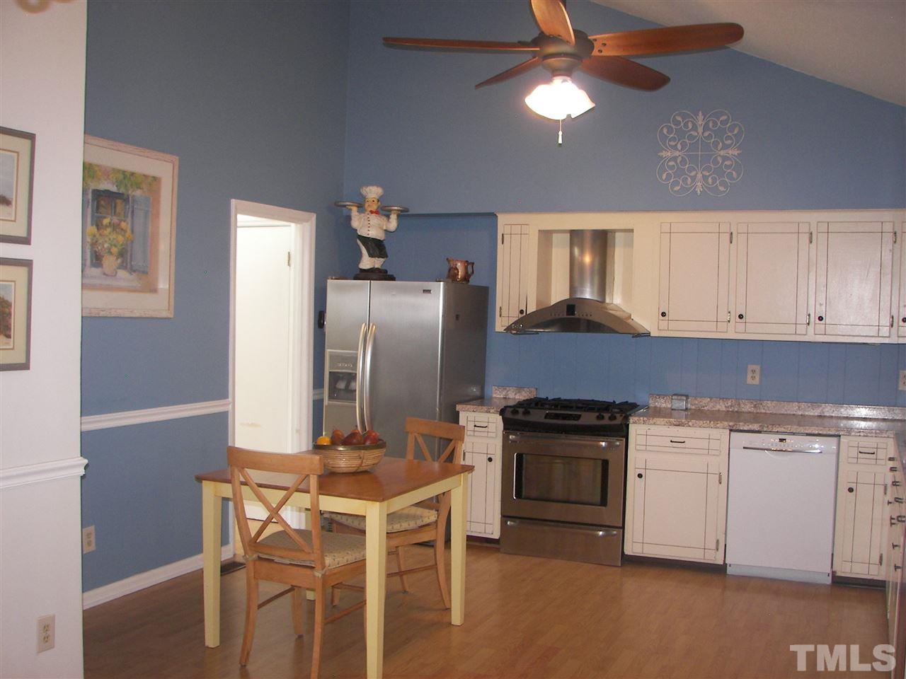 5016 Raintree Road Durham, NC 27712 - Photo 13 of 22 a kitchen with cabinets a sink stainless steel appliances and a window