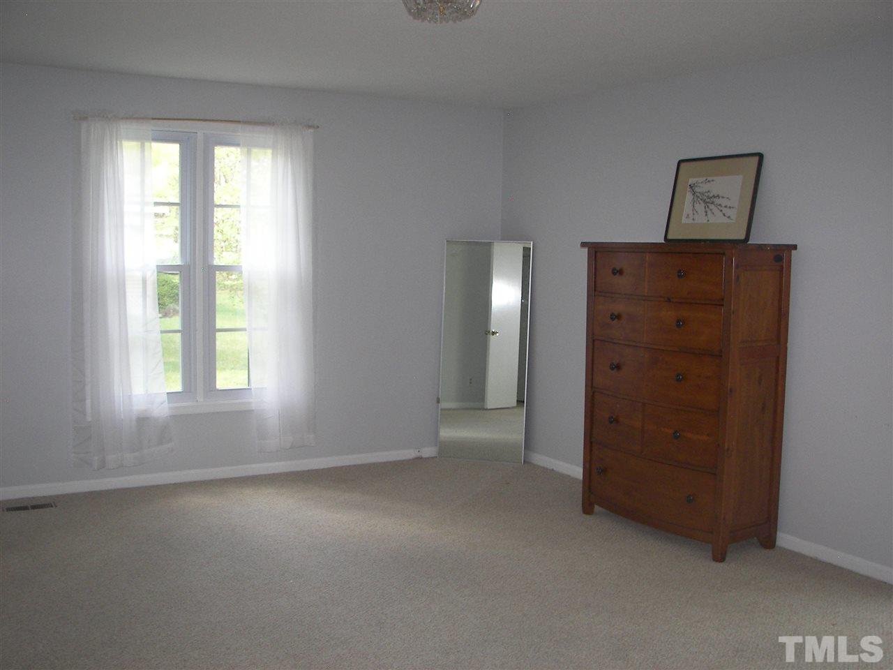 5016 Raintree Road Durham, NC 27712 - Photo 15 of 22 an empty room with windows and closet