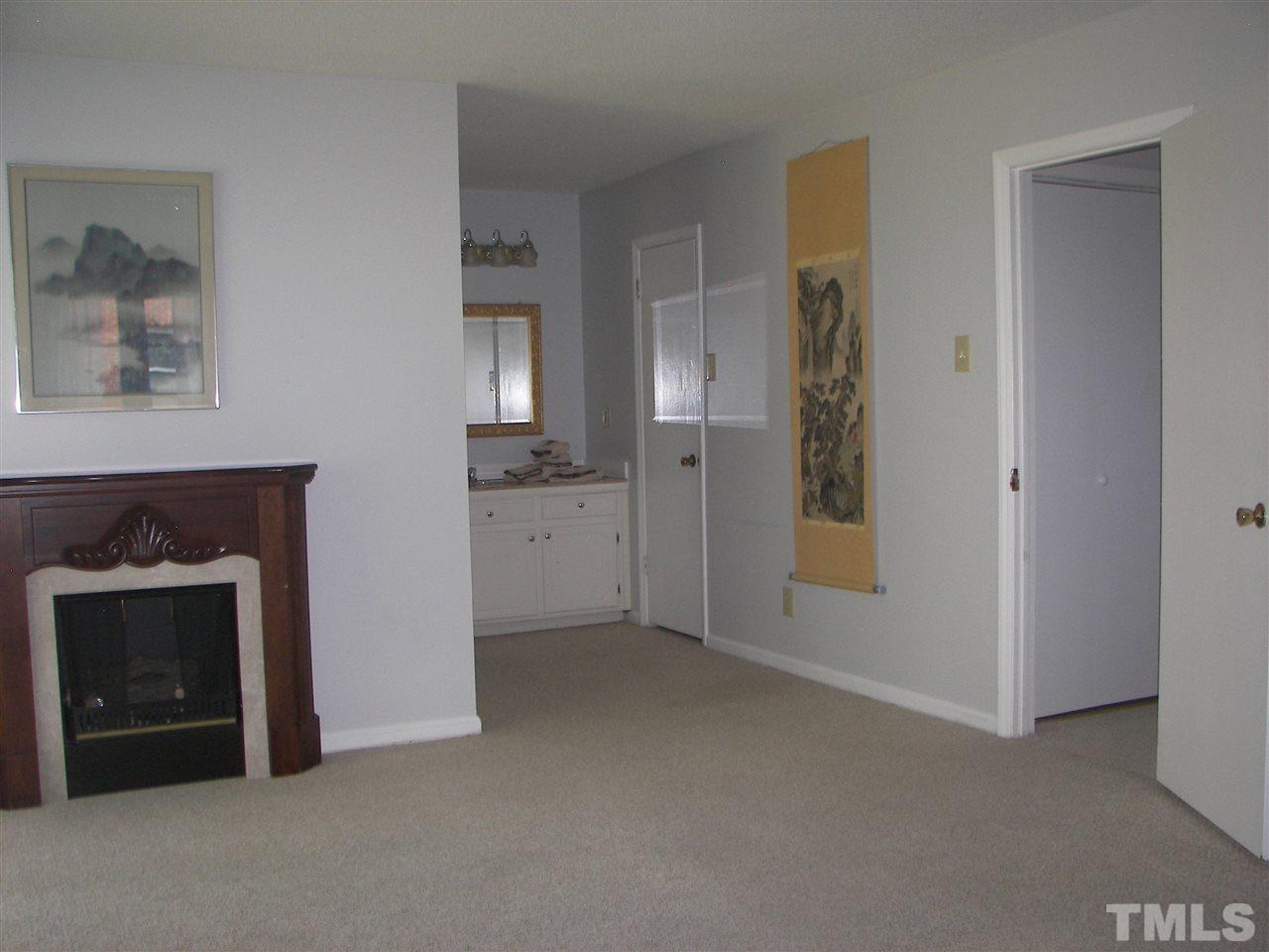 5016 Raintree Road Durham, NC 27712 - Photo 17 of 22 a view of an empty room and fire place