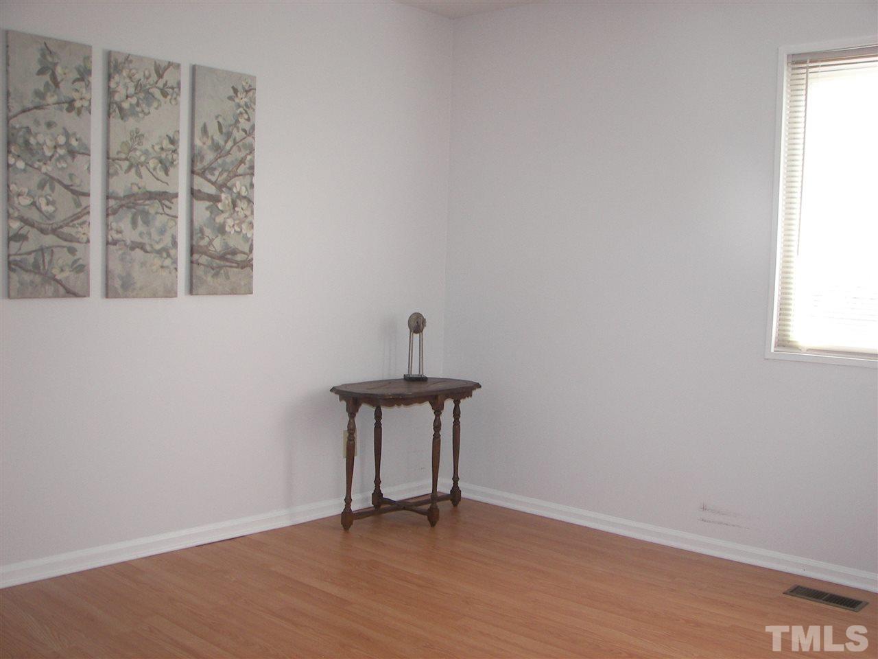 5016 Raintree Road Durham, NC 27712 - Photo 18 of 22 a view of a room with wooden floor and a window