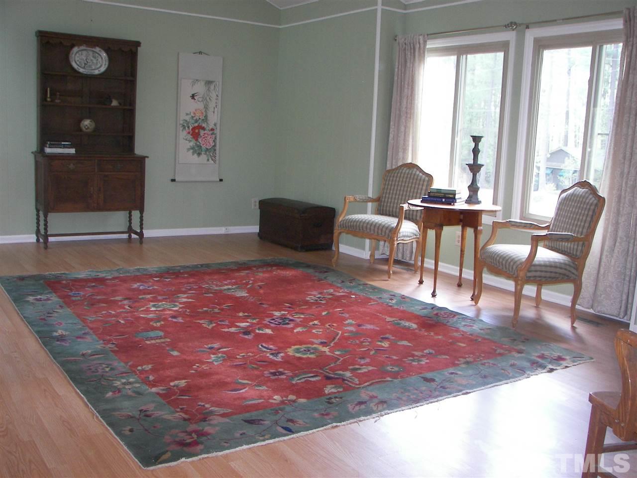 5016 Raintree Road Durham, NC 27712 - Photo 3 of 22 a living room with furniture and a rug