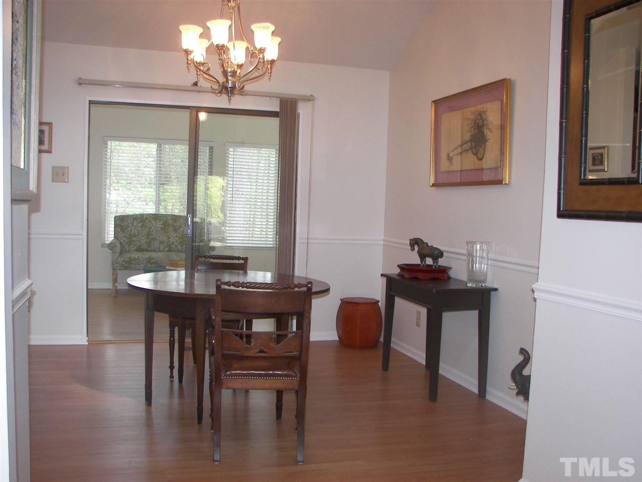 5016 Raintree Road Durham, NC 27712 - Photo 7 of 22 a view of a dining room with furniture window and wooden floor