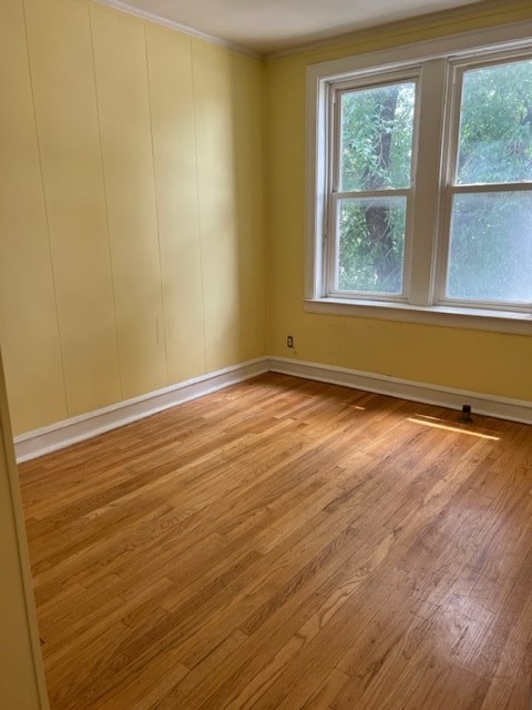 2838 West Addison Street, Unit 2S Chicago, IL 60618 - Photo 14 of 15 a view of an empty room with wooden floor and a window