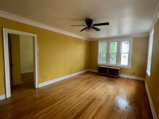 2838 West Addison Street, Unit 2S Chicago, IL 60618 - Photo 3 of 15 an empty room with wooden floor and windows