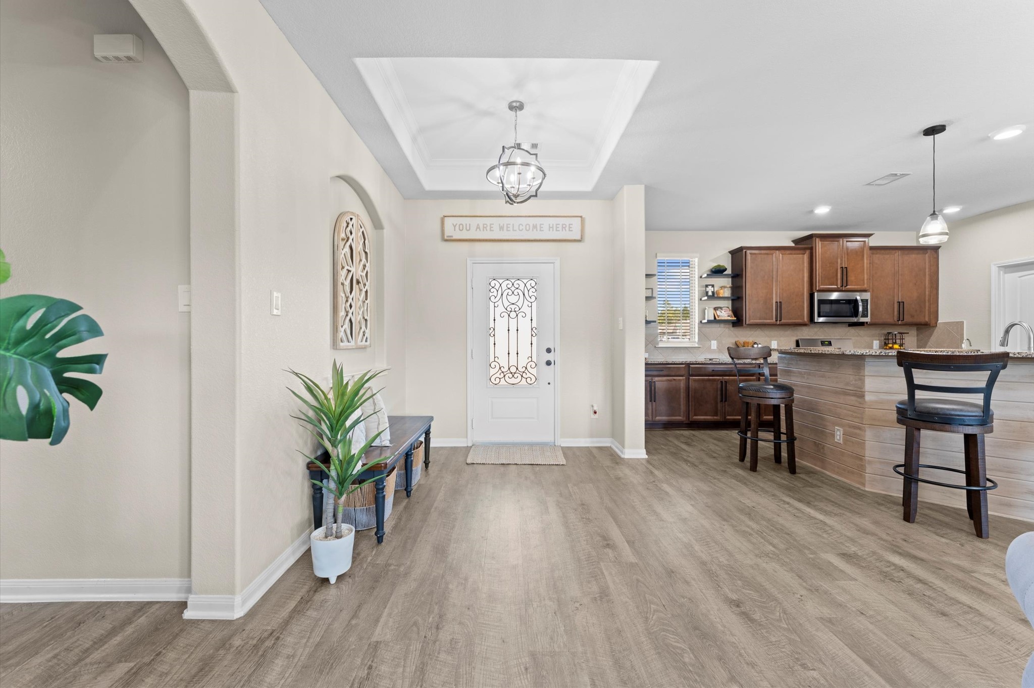 9729 Hidalgo Street Conroe, TX 77303 - Photo 14 of 38 Bright and welcoming entryway leads to an open kitchen with modern fixtures, and a cozy breakfast bar. Perfect for entertaining and daily living.