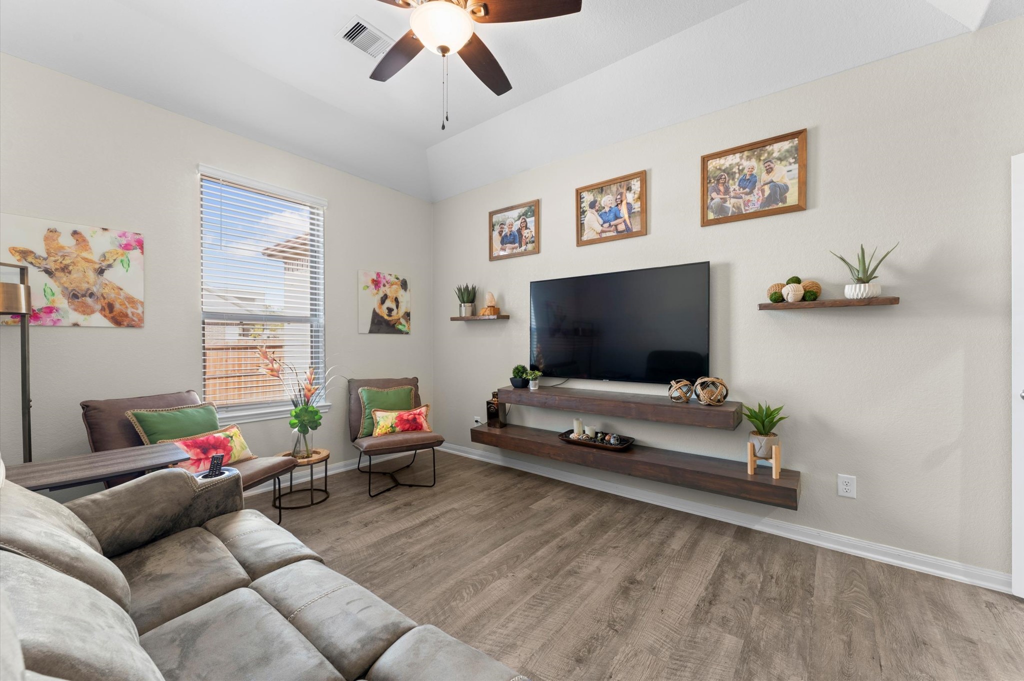 9729 Hidalgo Street Conroe, TX 77303 - Photo 20 of 38 Neutral walls and wood-look vinyl flooring along with a large window allows natural light, creating a warm ambiance.