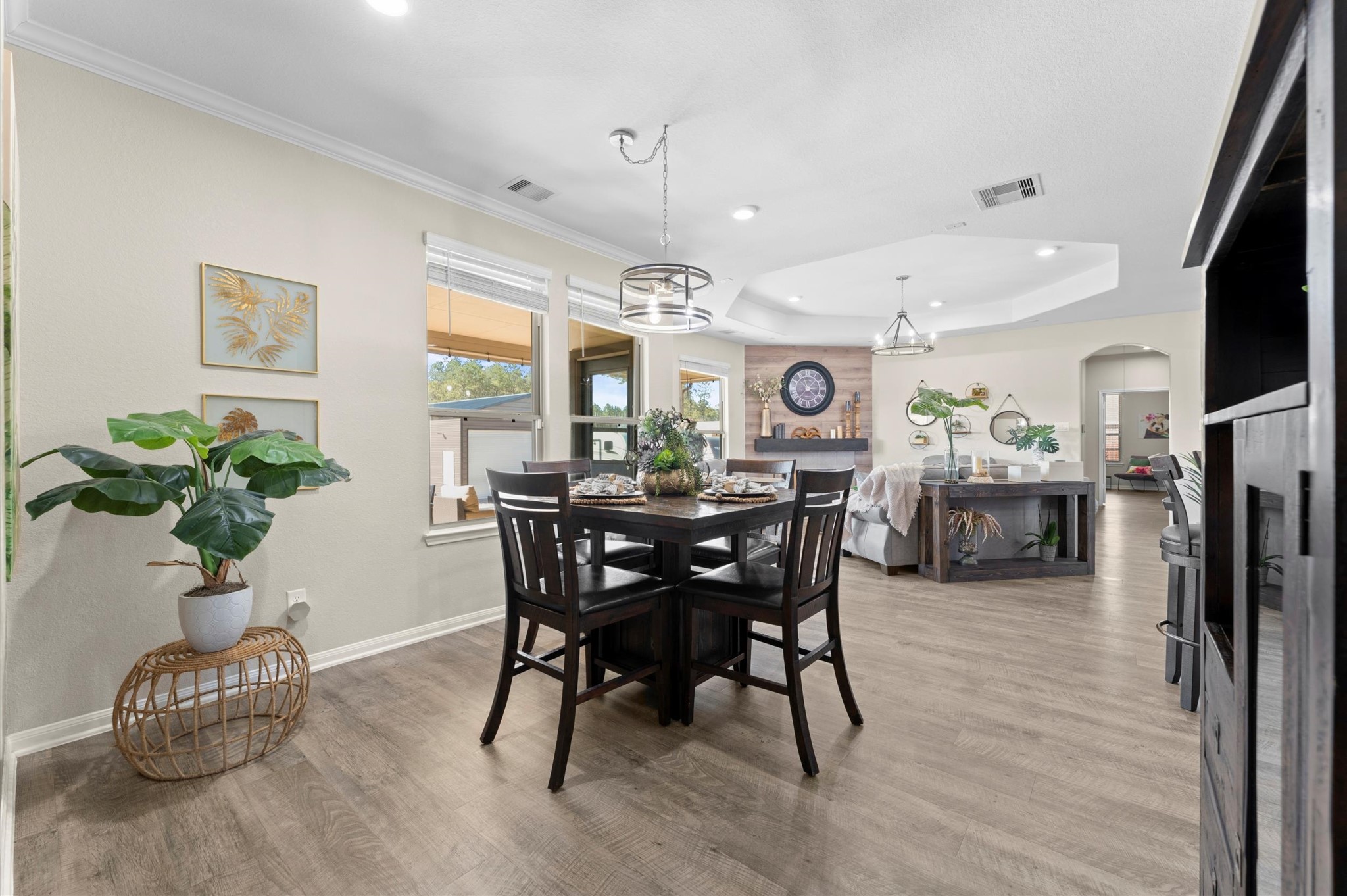 9729 Hidalgo Street Conroe, TX 77303 - Photo 10 of 38 This open-concept features modern lighting and is bright, with large windows offering a welcoming atmosphere.