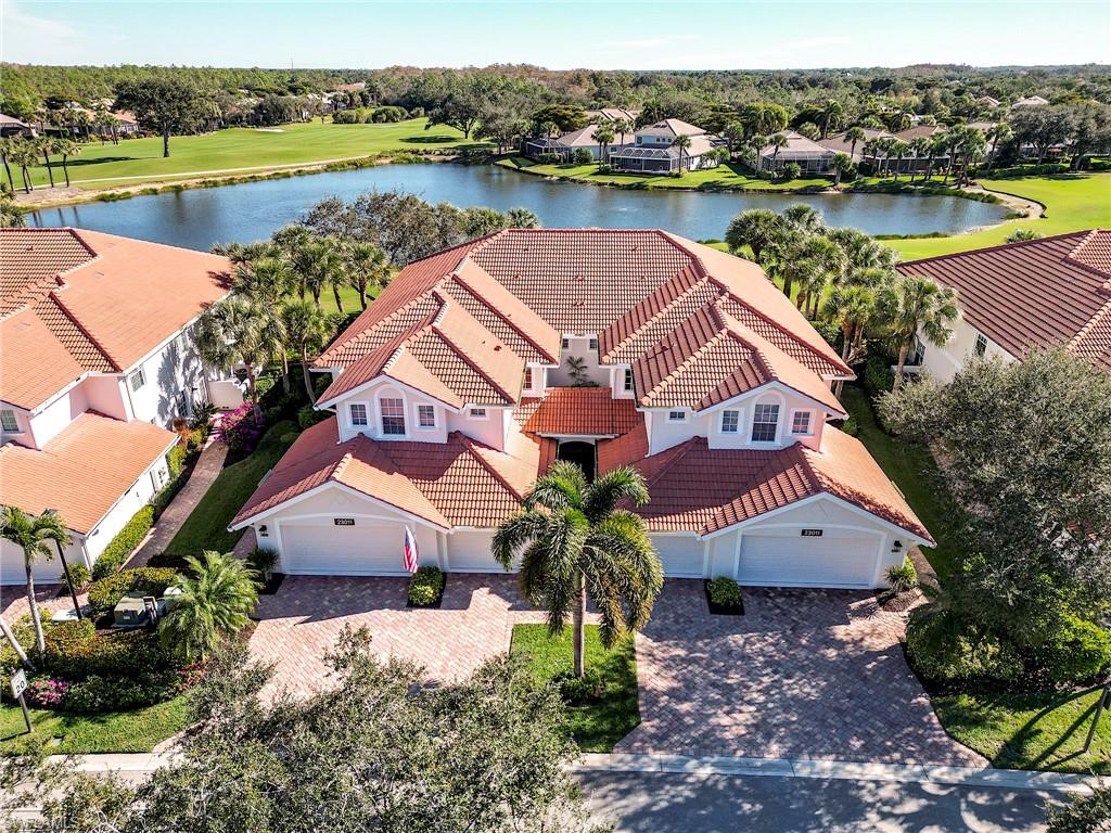 an aerial view of a house with outdoor space and lake view