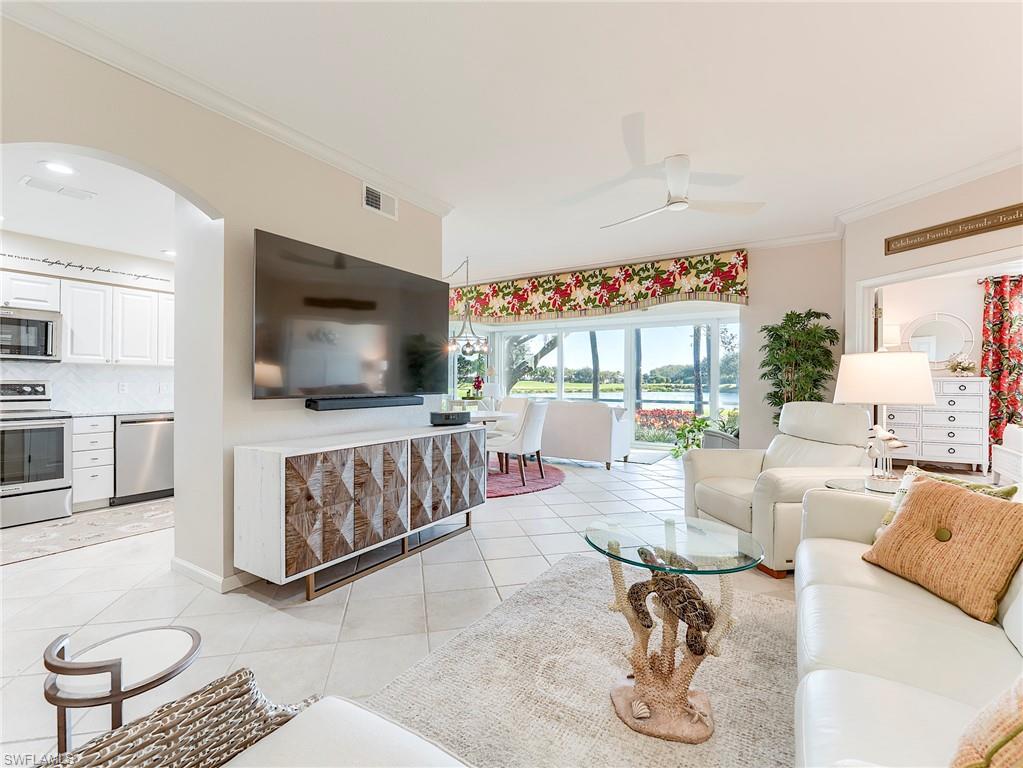 23011 Rosedale Drive, Unit 101 Estero, FL 34135 - Photo 17 of 34 a living room with furniture and a flat screen tv