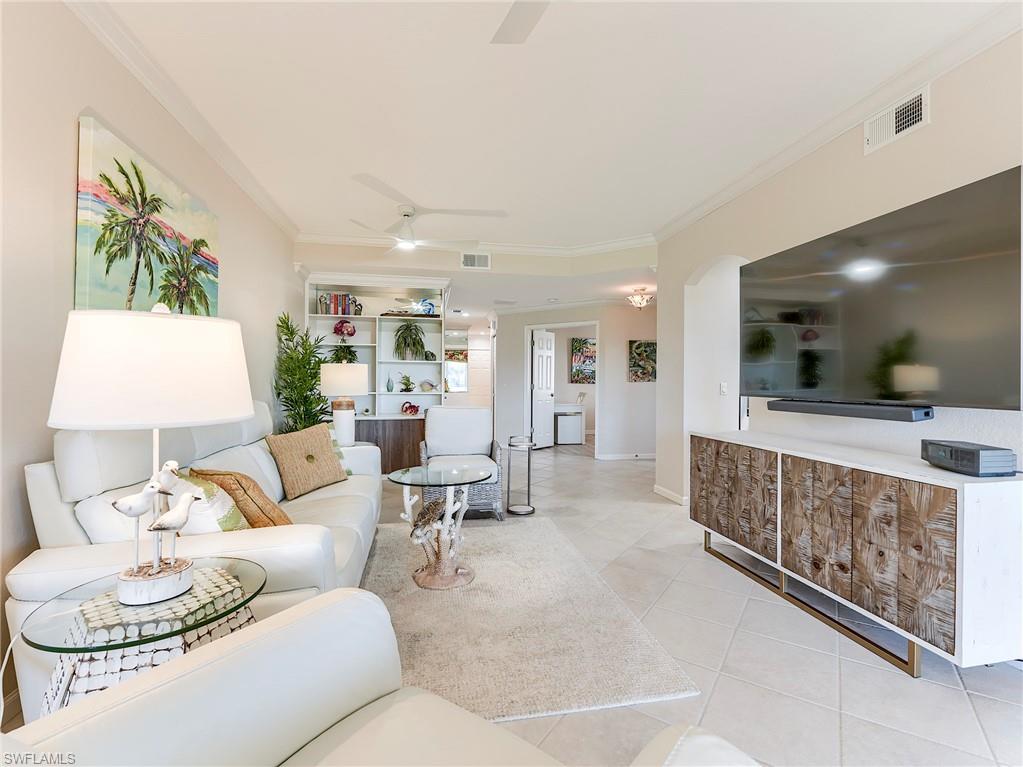 23011 Rosedale Drive, Unit 101 Estero, FL 34135 - Photo 18 of 34 a living room with furniture and a flat screen tv