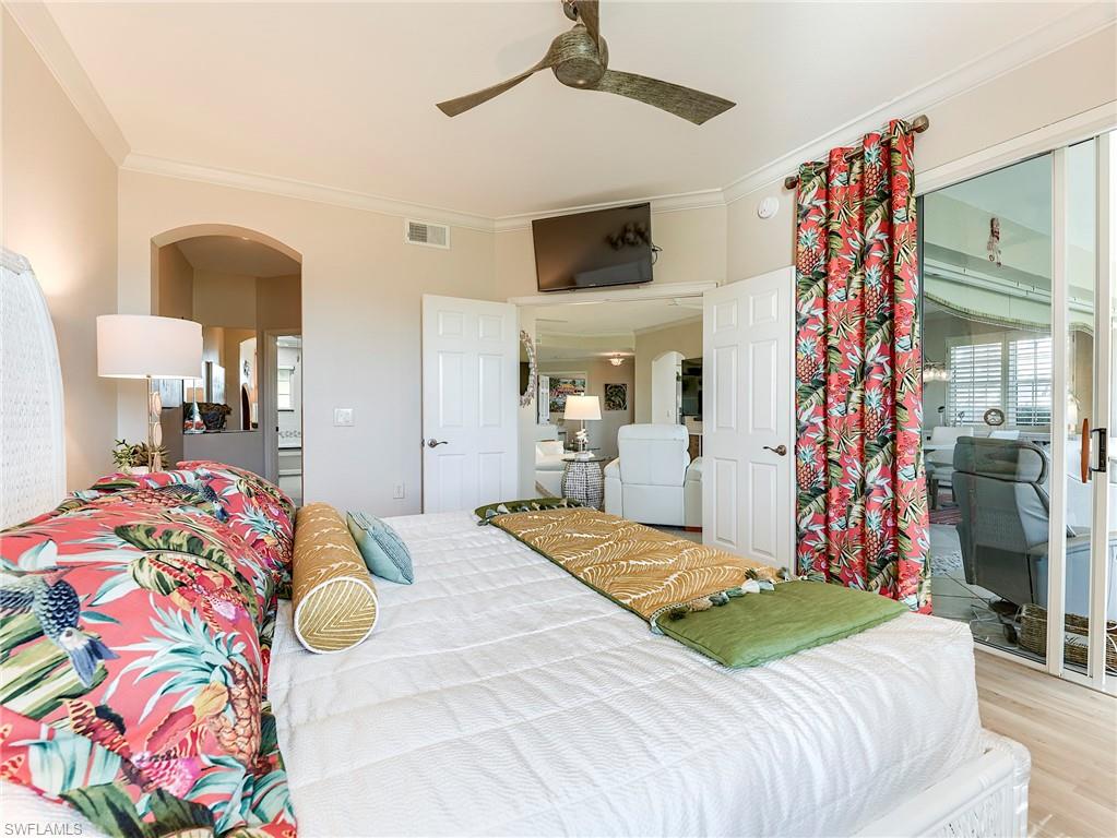 23011 Rosedale Drive, Unit 101 Estero, FL 34135 - Photo 22 of 34 a bedroom with a bed and a lamp