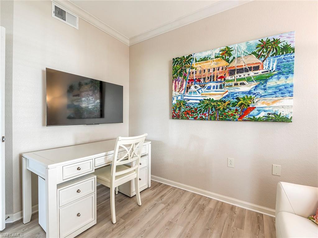 23011 Rosedale Drive, Unit 101 Estero, FL 34135 - Photo 26 of 34 a living room with furniture and a flat screen tv
