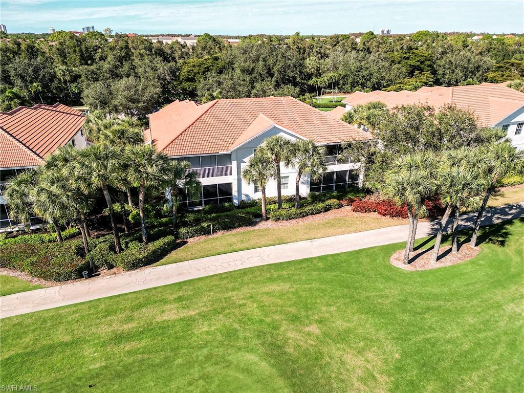 23011 Rosedale Drive, Unit 101 Estero, FL 34135 - Photo 3 of 34 a view of a house with a yard table and chairs