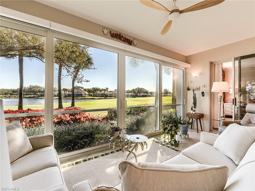 23011 Rosedale Drive, Unit 101 Estero, FL 34135 - Photo 7 of 34 a living room with furniture and a floor to ceiling window