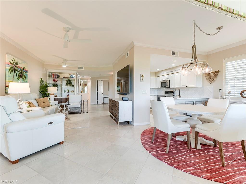 23011 Rosedale Drive, Unit 101 Estero, FL 34135 - Photo 9 of 34 a living room with furniture and a chandelier