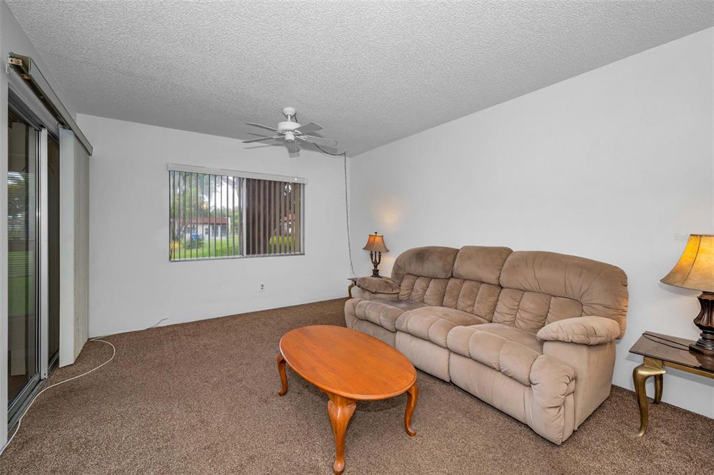3116 Highlands Boulevard, Unit 3116 Palm Harbor, FL 34684 - Photo 15 of 56 a living room with furniture and a window