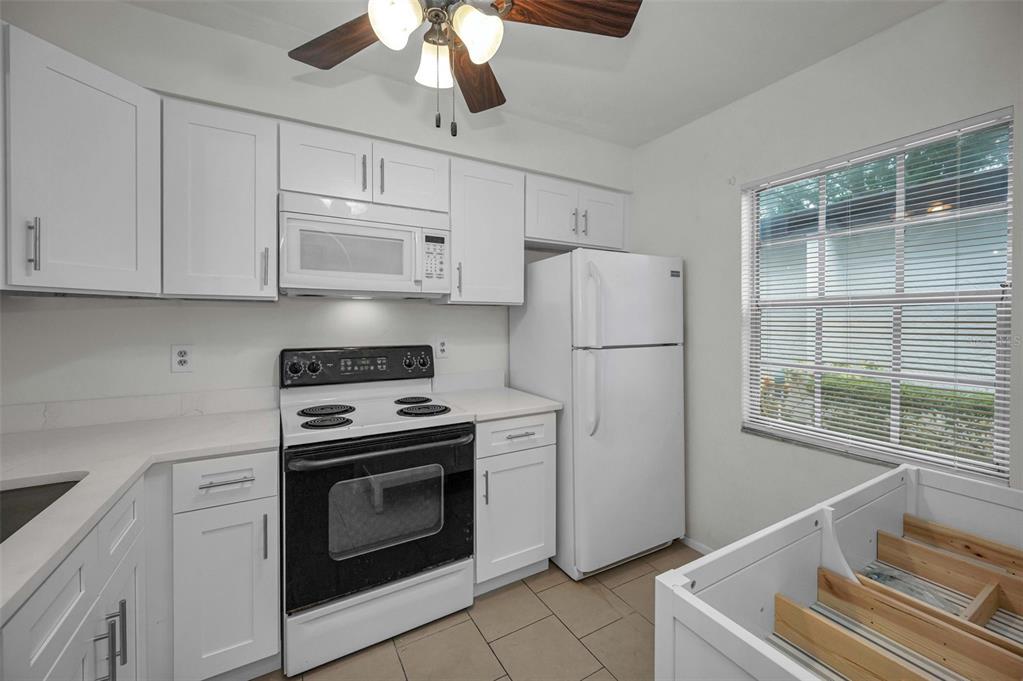 3116 Highlands Boulevard, Unit 3116 Palm Harbor, FL 34684 - Photo 16 of 56 a kitchen with cabinets and stainless steel appliances