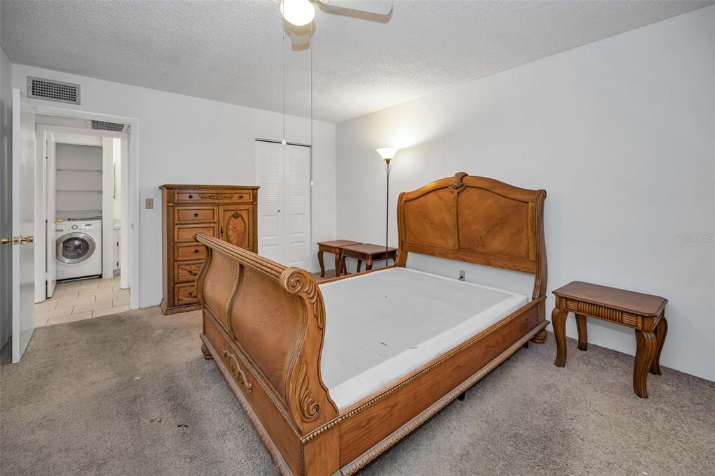 3116 Highlands Boulevard, Unit 3116 Palm Harbor, FL 34684 - Photo 21 of 56 a bed room with a bed and a chair