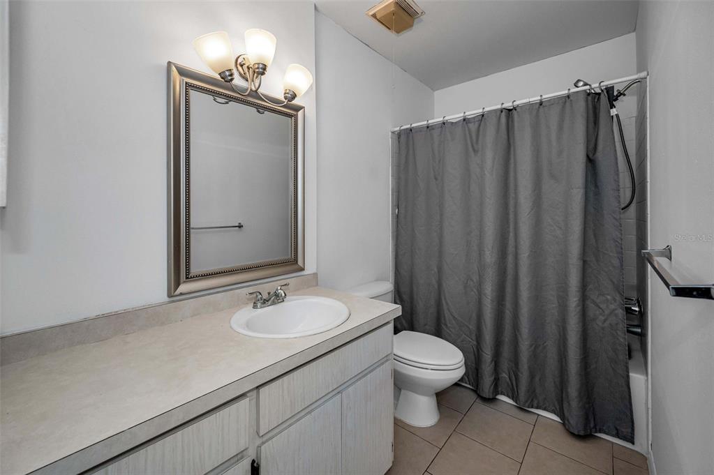 3116 Highlands Boulevard, Unit 3116 Palm Harbor, FL 34684 - Photo 26 of 56 a bathroom with a granite countertop sink toilet and shower