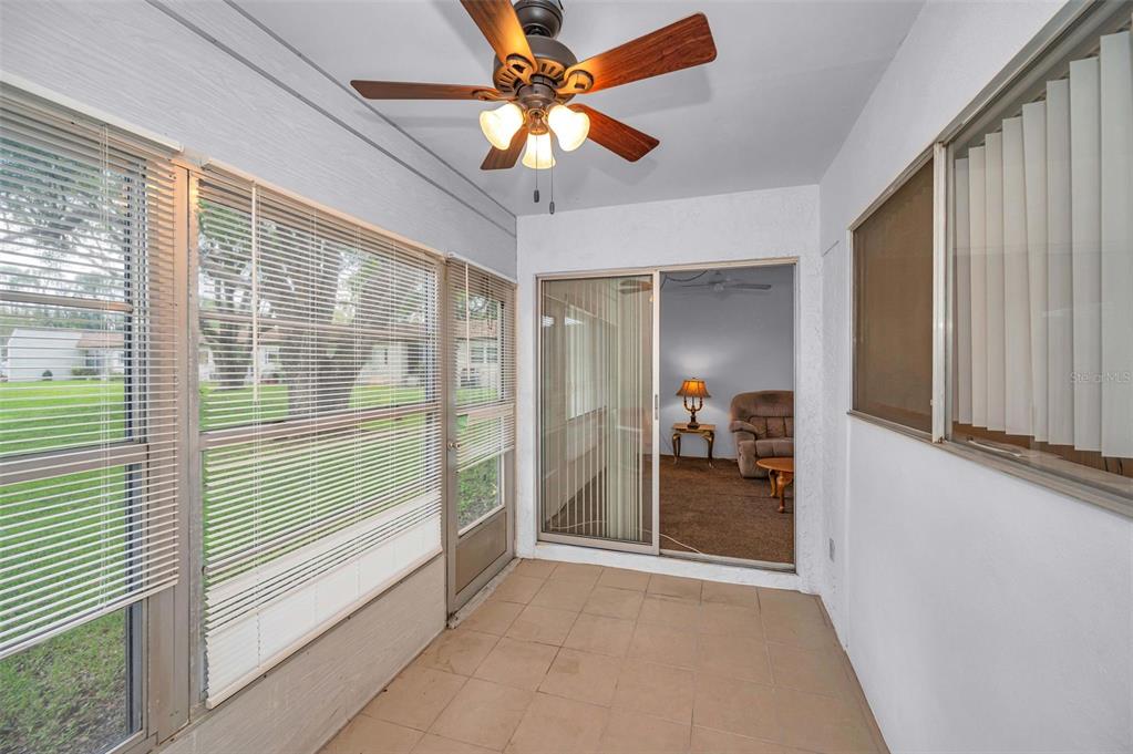 3116 Highlands Boulevard, Unit 3116 Palm Harbor, FL 34684 - Photo 30 of 56 a view of a livingroom with a chandelier fan and a window