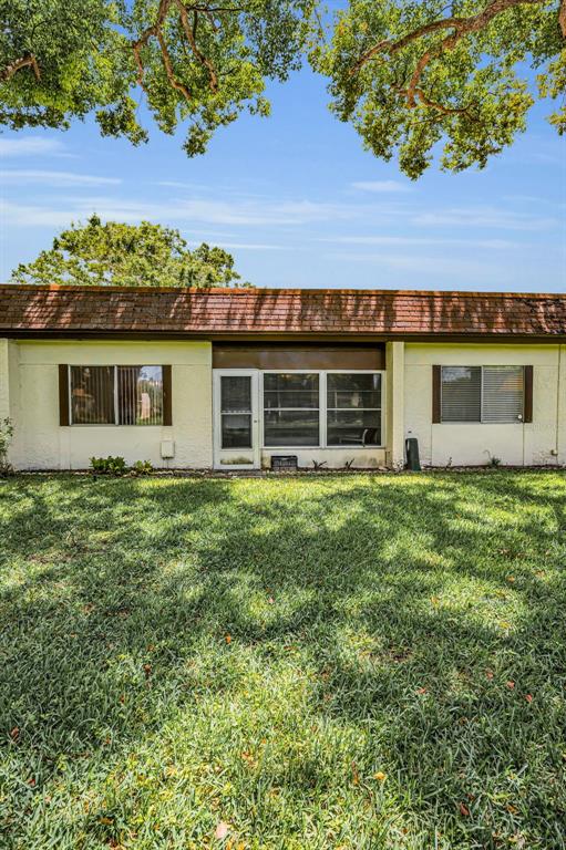3116 Highlands Boulevard, Unit 3116 Palm Harbor, FL 34684 - Photo 36 of 56 a view of a house with a backyard